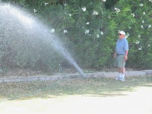 a sprinkler repair tech uses an above ground line to test temporary head placement